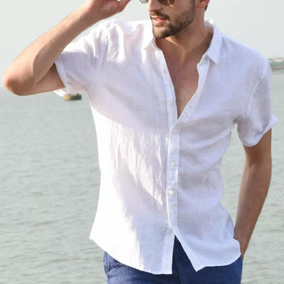 Man wearing white summer short-sleeved casual button-up shirt with lapel collar by the water