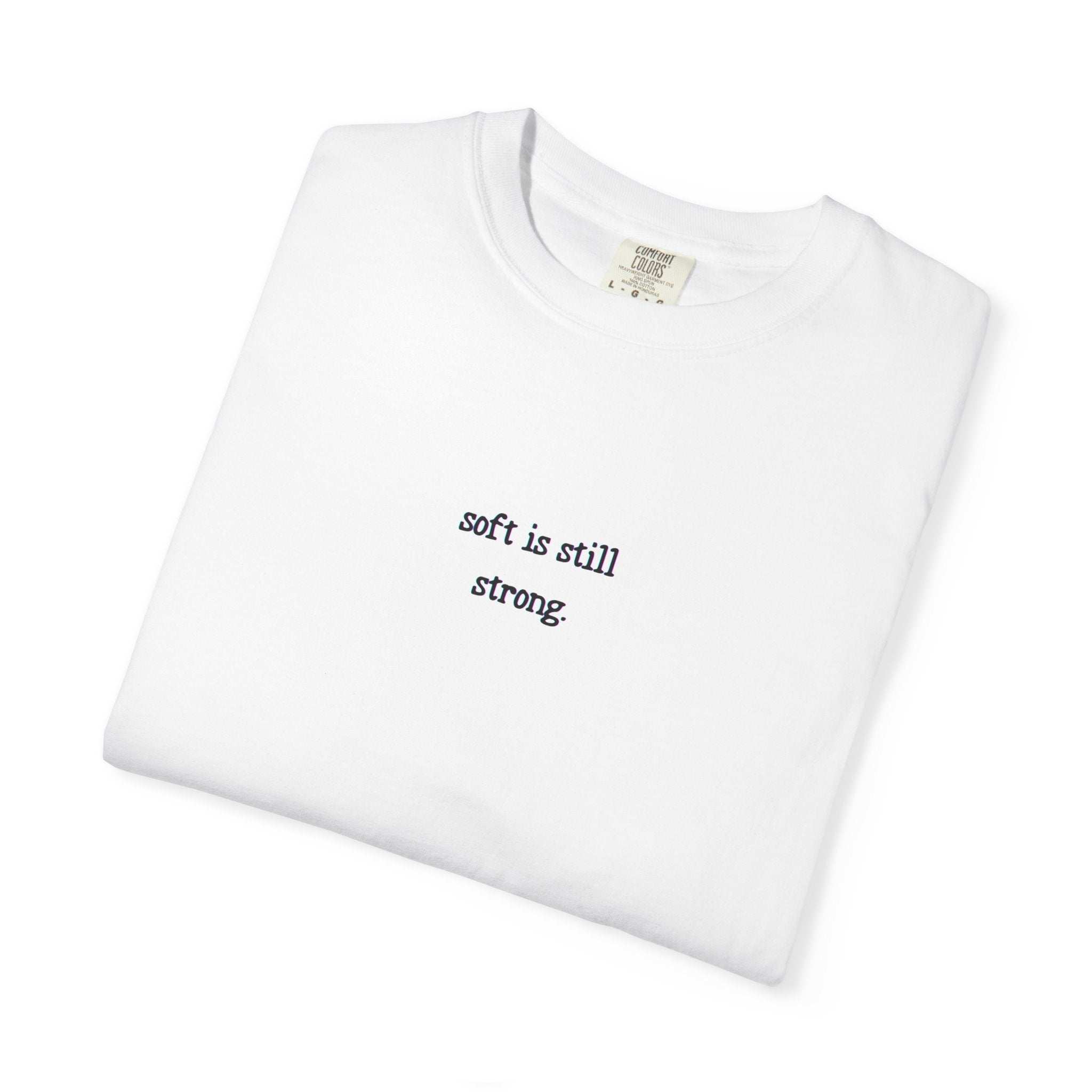White t-shirt with 'soft is still strong' text on a white background
