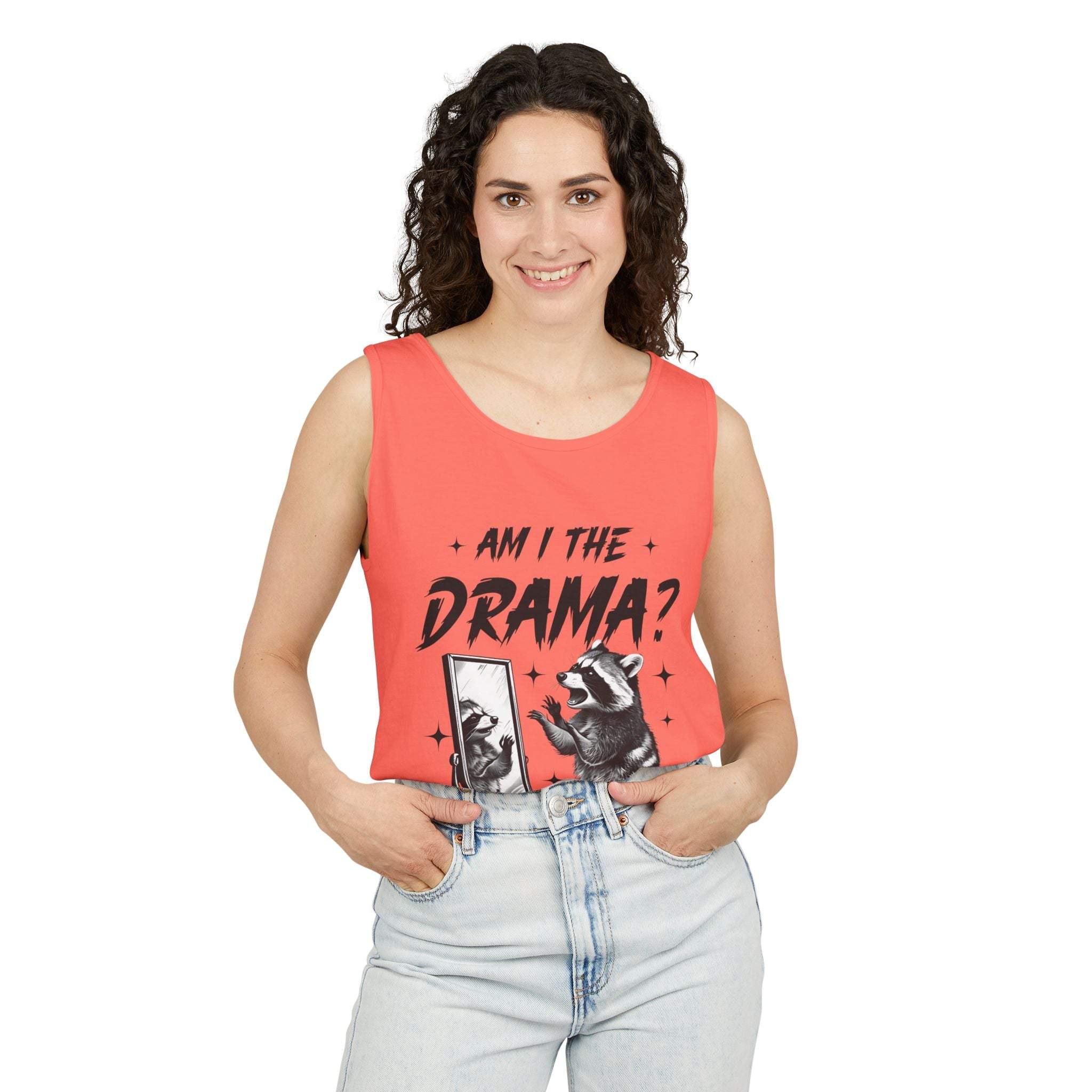 Woman wearing coral tank top with "Am I The Drama?" raccoon design and light denim jeans