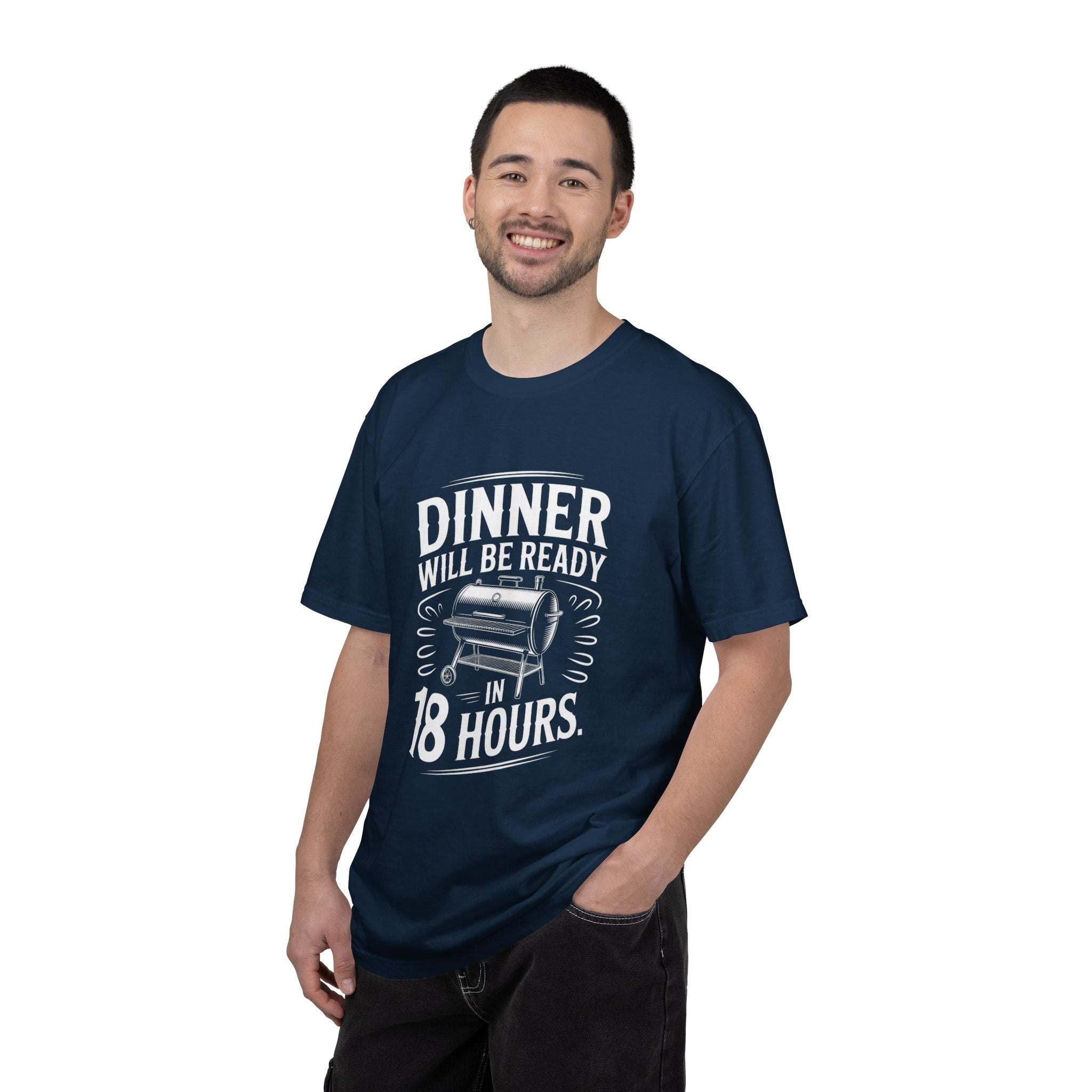 Dinner Will Be Ready in 18 Hours meat smoker graphic navy blue t-shirt worn by smiling man