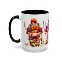Ceramic Christmas coffee mug with festive Scottish Highland cow wearing colorful hat and holiday lights, black handle and interior.