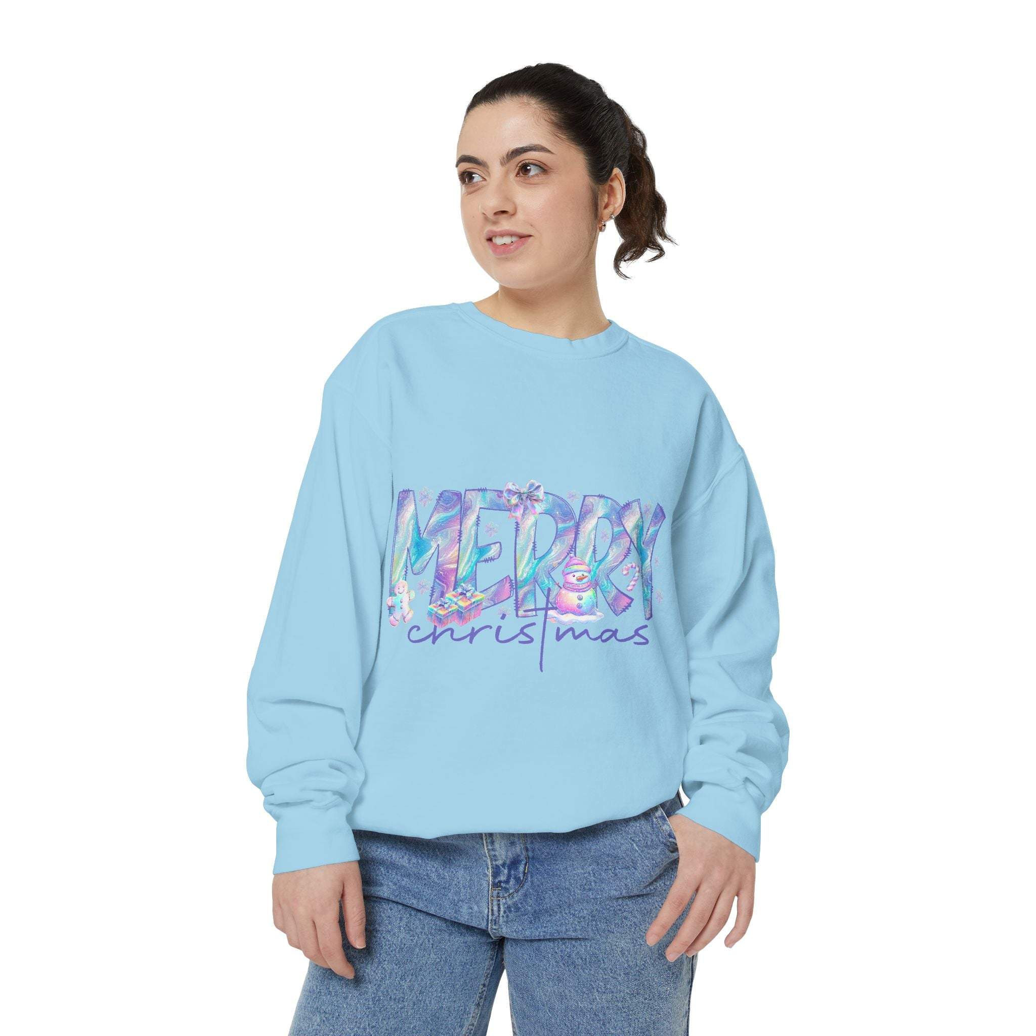 Light blue sweatshirt with iridescent Merry Christmas design worn by woman in jeans