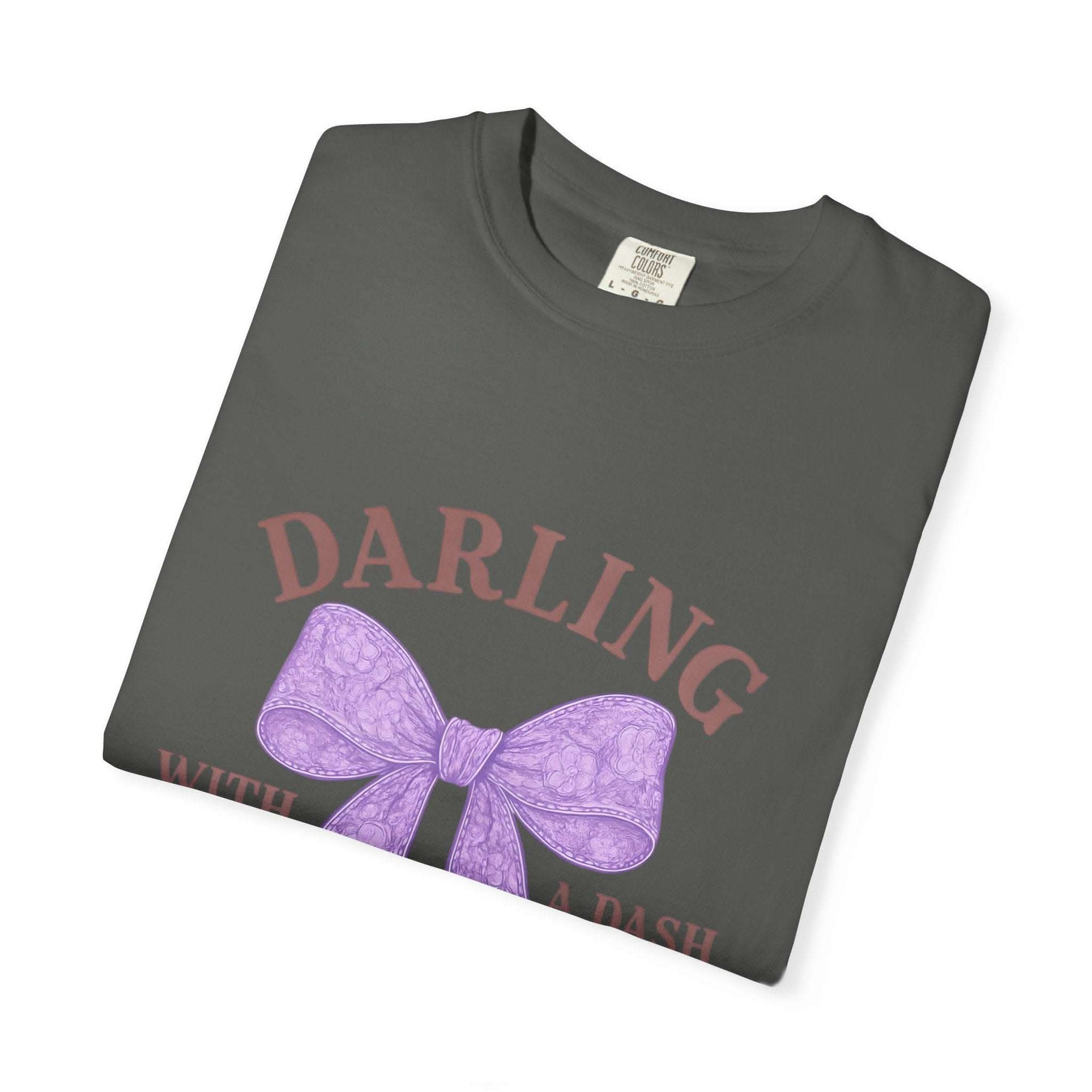 Folded gray t-shirt with purple bow and text on a white background