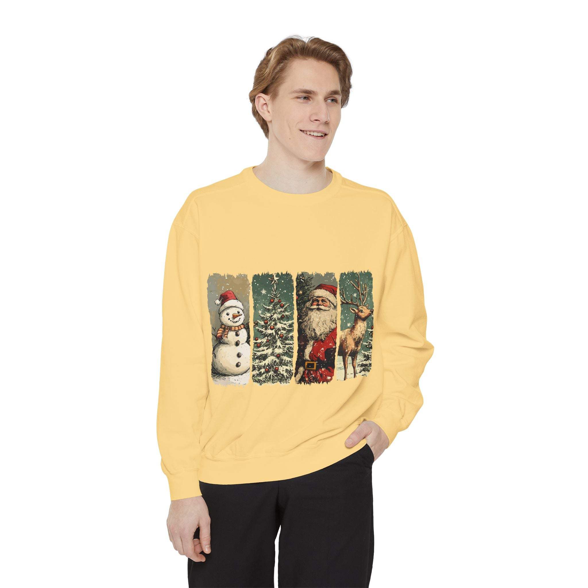Man wearing yellow vintage Christmas sweatshirt with watercolor snowman, tree, Santa, and reindeer design