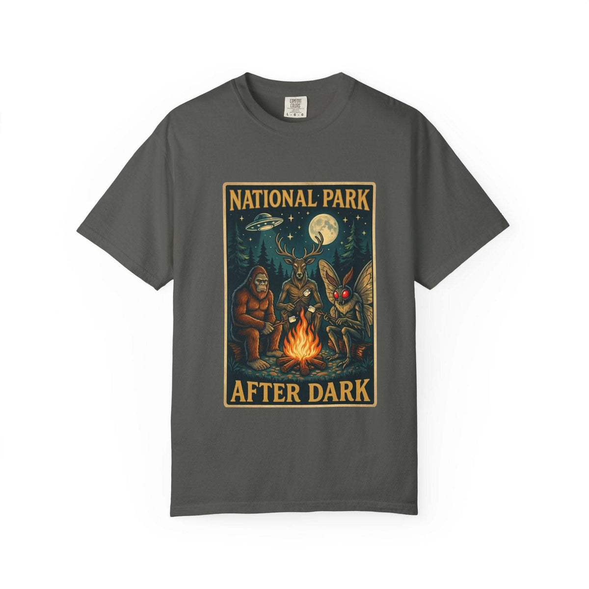 National Park After Dark t-shirt featuring campfire, Sasquatch, Mothman, and nocturnal creatures in a vintage woodland night scene
