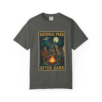 National Park After Dark t-shirt featuring campfire, Sasquatch, Mothman, and nocturnal creatures in a vintage woodland night scene