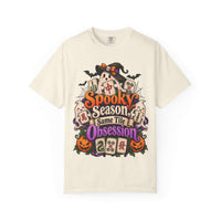 Flat lay of an ivory Halloween mahjong T-shirt with ghosts, pumpkins, mahjong tiles and “Spooky Season, Same Tile Obsession” lettering.
