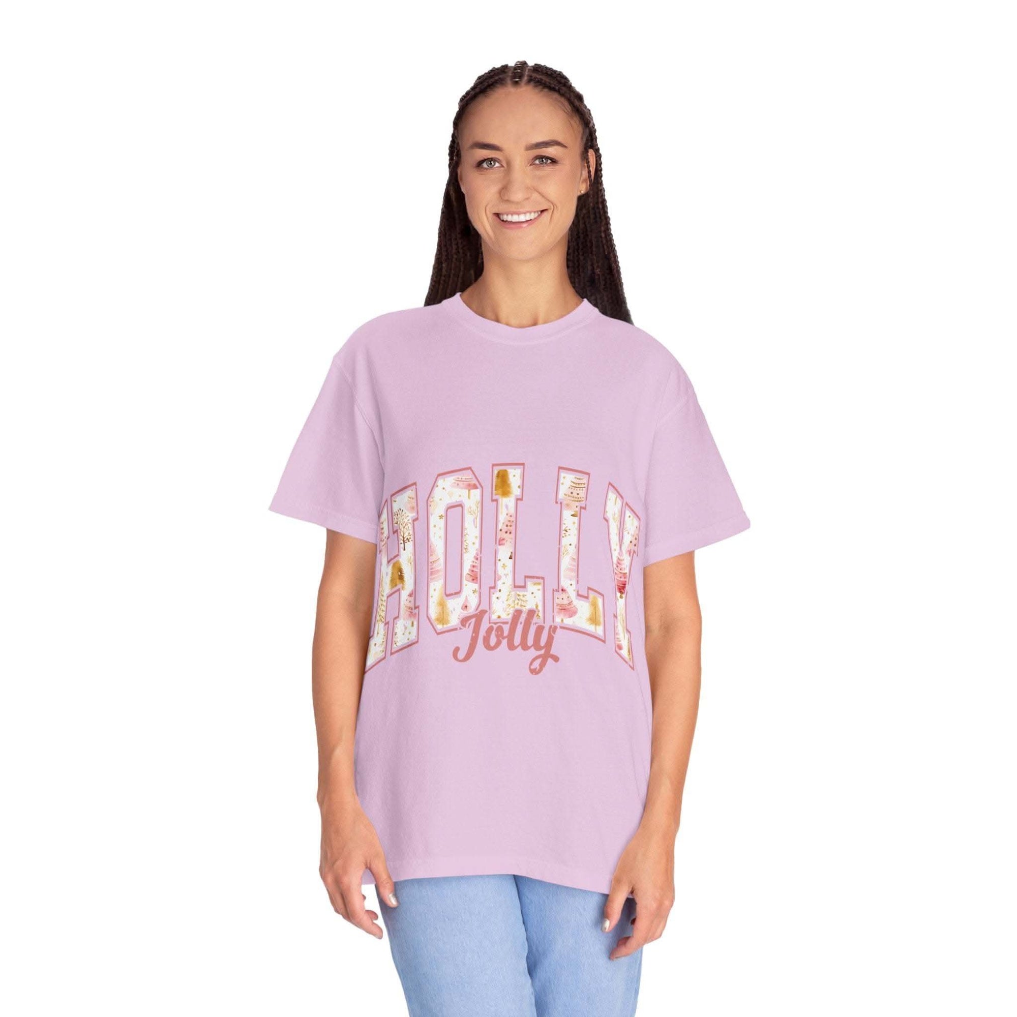 Woman wearing lavender Varsity Holly Jolly T-shirt with festive text, relaxed fit and garment-dyed cotton fabric