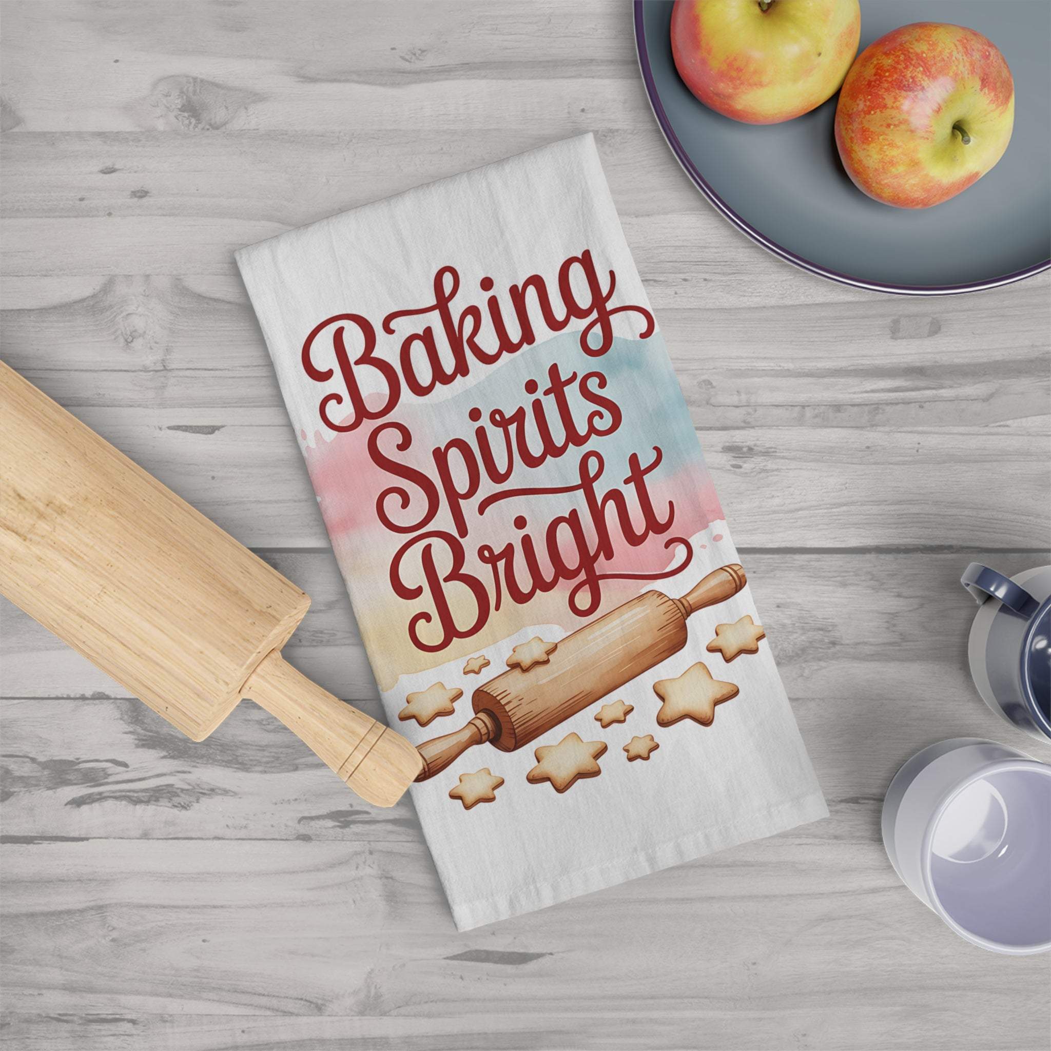 Kitchen towel with "Baking Spirits Bright" design featuring rolling pin and star cookies on white cotton fabric