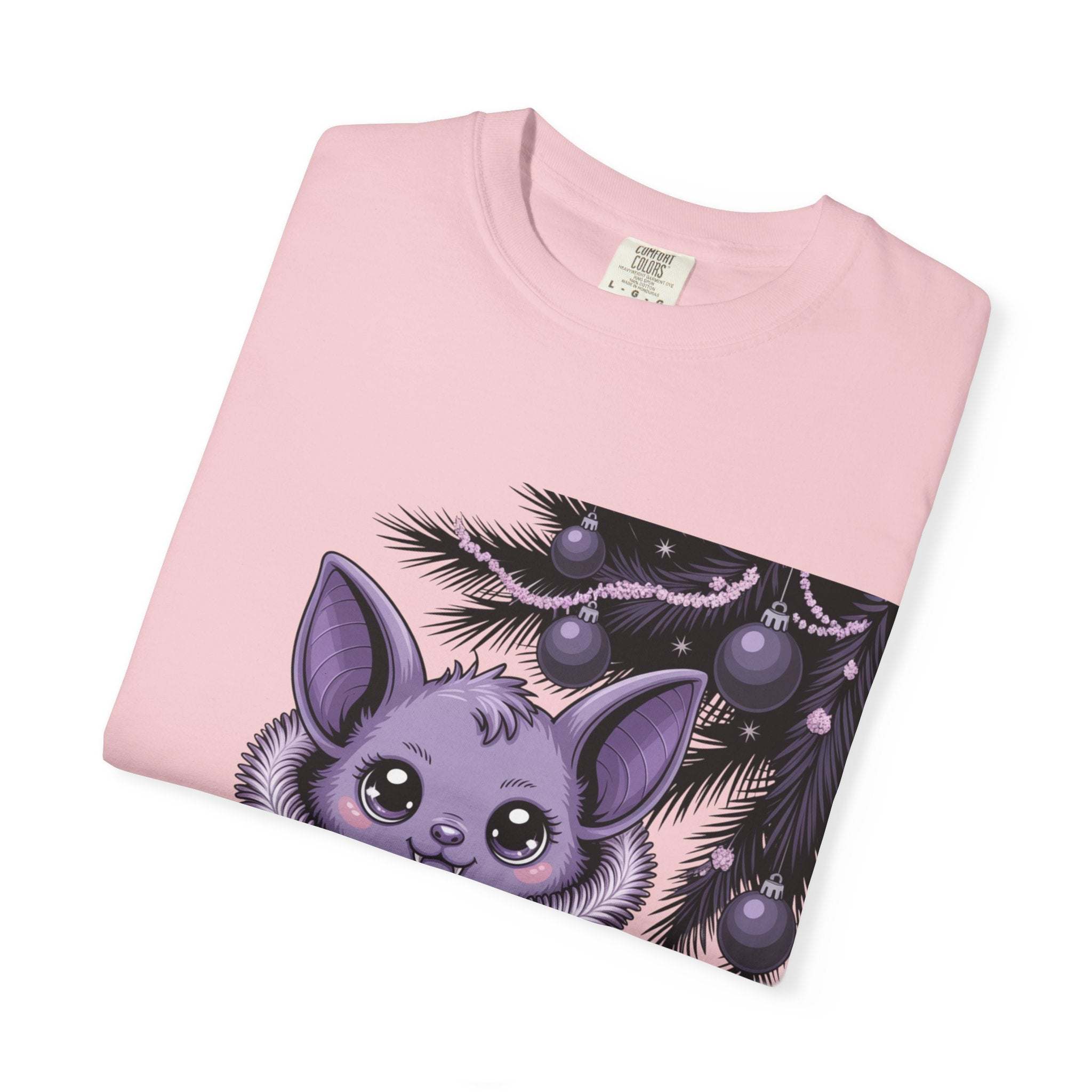 Pink sweatshirt with a purple creature and Christmas tree design on a white background