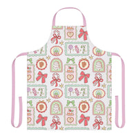 Retro Christmas Frames apron with festive bows and candy designs, pink straps, and soft polyester fabric for holiday cooking.