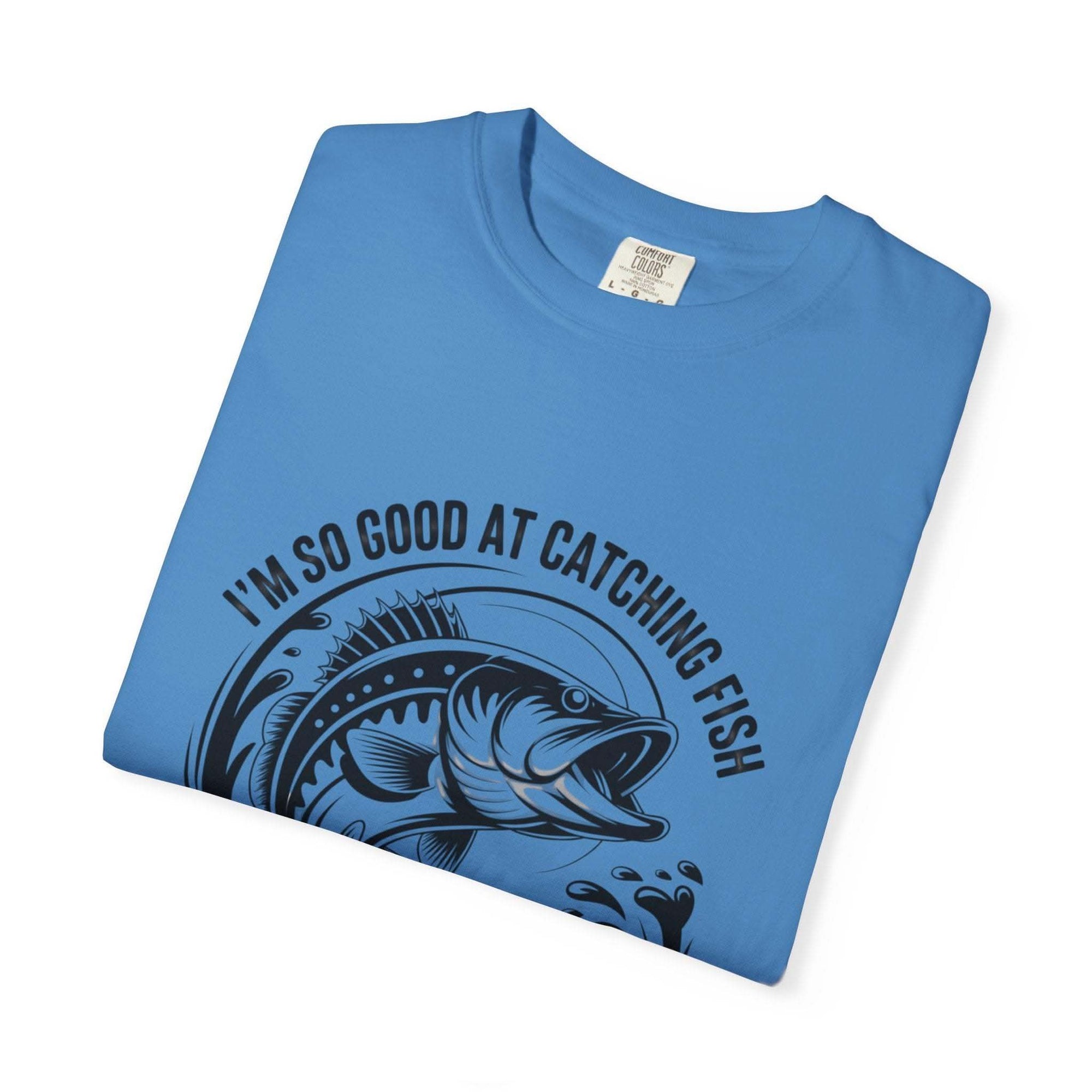 Fishing T-Shirt with humorous "So Good At Catching Fish That The Fish Tell Stories About Me" text, soft cotton and relaxed fit.