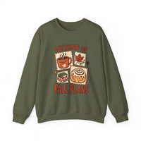 An olive green crewneck sweatshirt featuring a graphic print of autumn-themed illustrations and the text 'MY KIND OF FALL PLANS' in red.