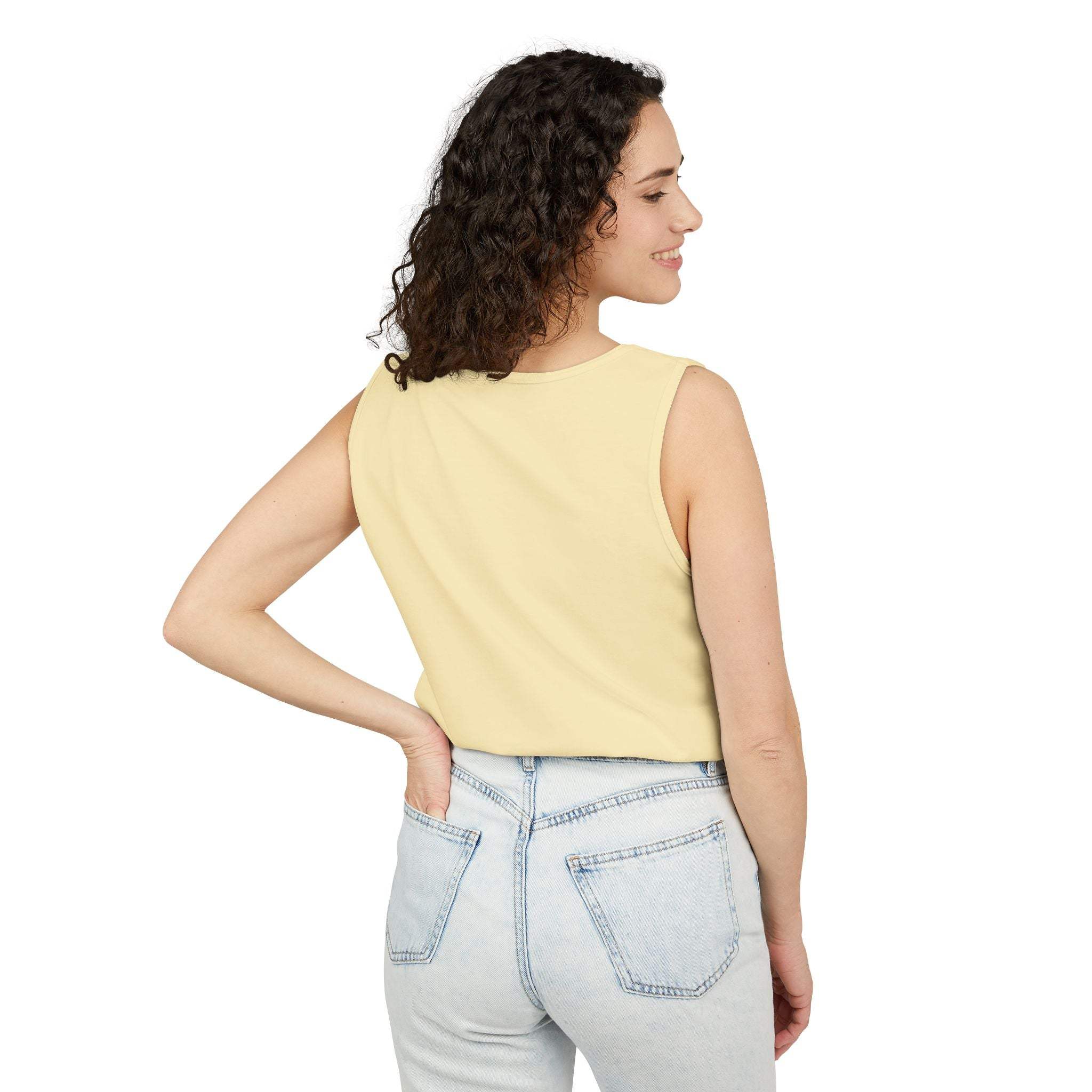 Woman wearing a casual yellow tank top paired with light blue jeans, showcasing the back view of the sleeveless design.