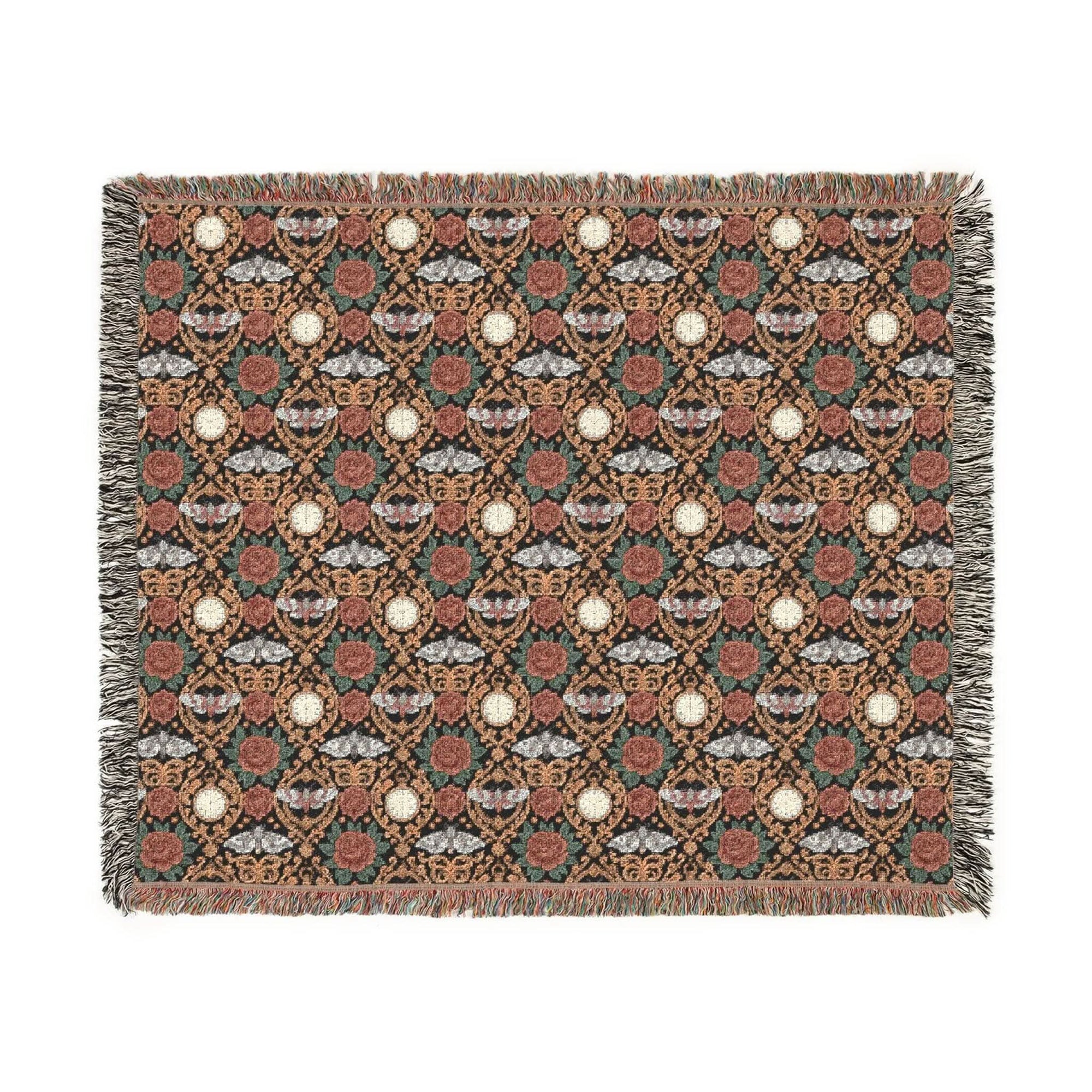 Victorian Gothmas Woven Blanket with candlelight-inspired colors and colorful fringed edges on a dark velvet background