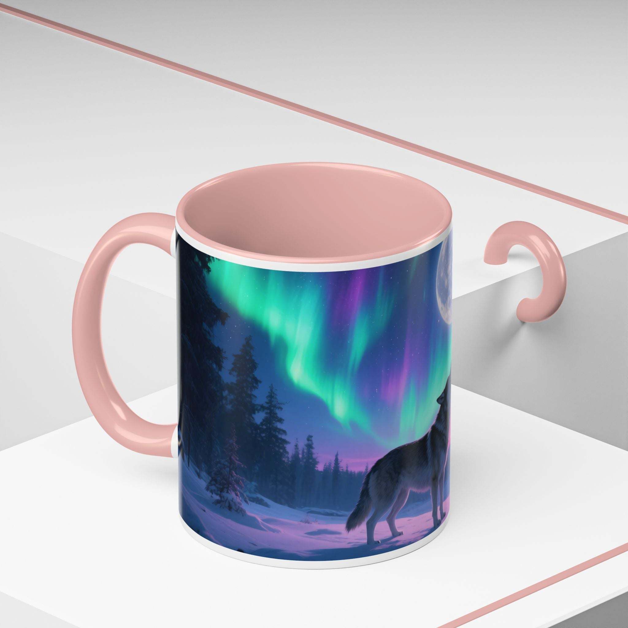 Ceramic mug with pink handle and interior featuring howling wolf and northern lights design
