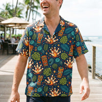 Navy tropical bowling Hawaiian shirt with tiki masks, bowling pins, and jungle leaves print, camp collar, and button-down style.