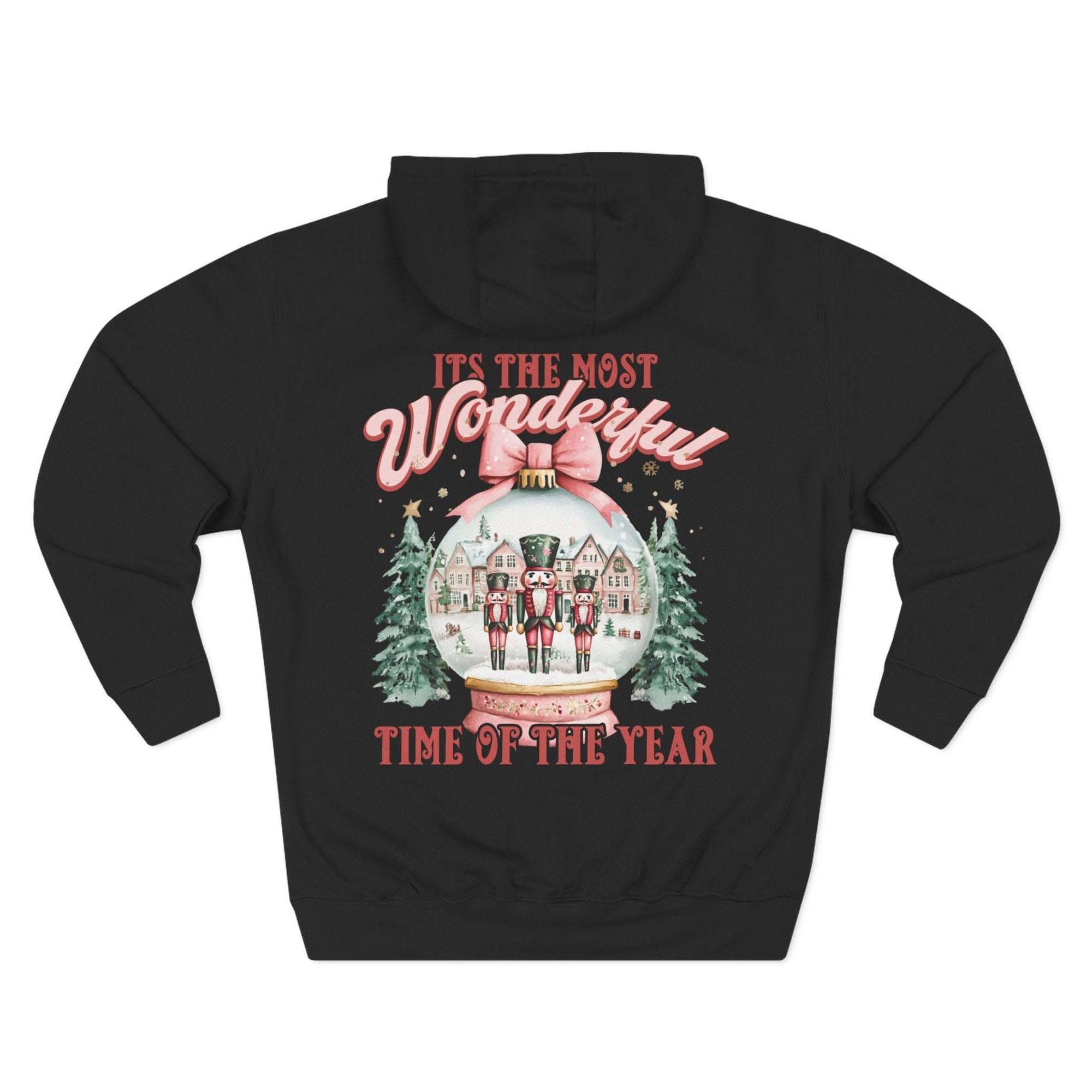 Black fleece hoodie with vintage pink snow globe and nutcracker design, festive winter holiday style