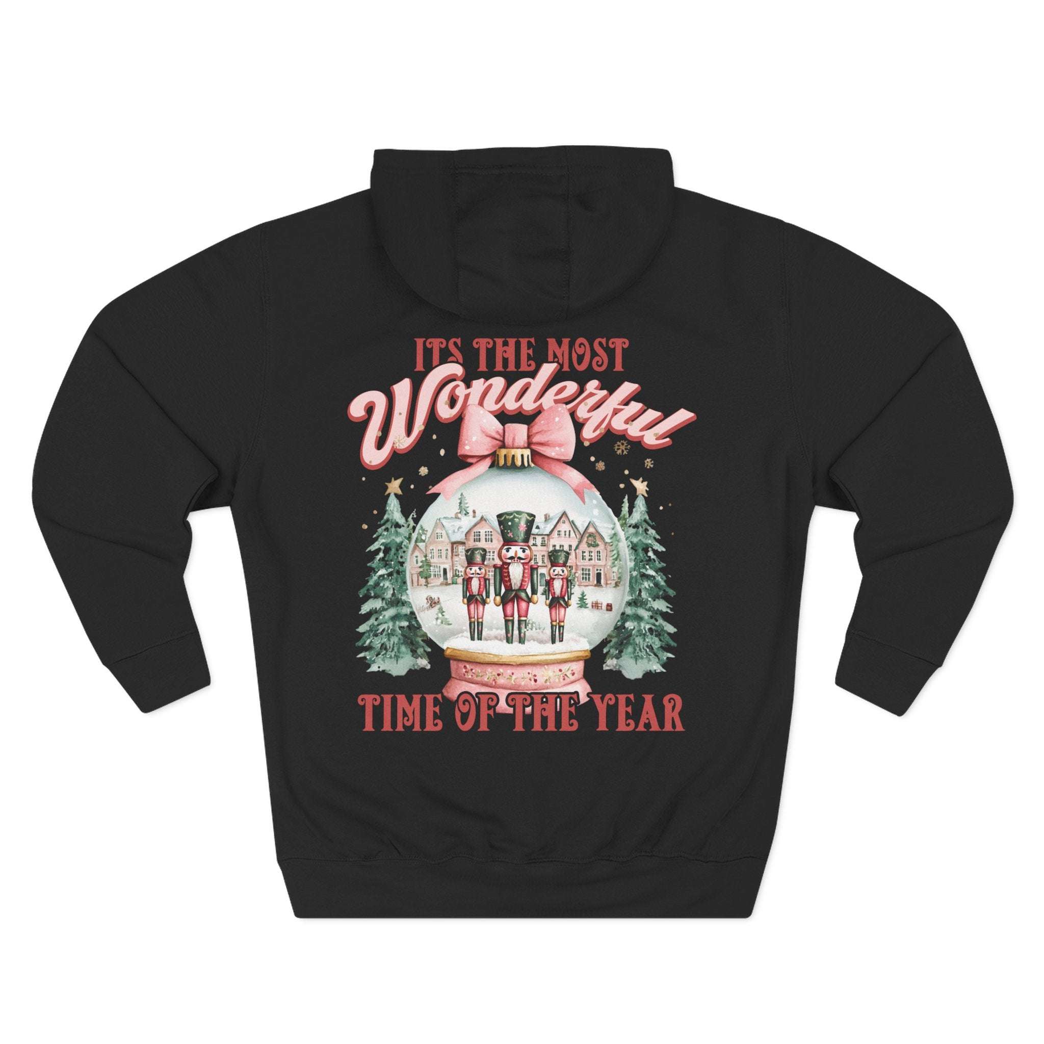 Black fleece hoodie with vintage pink snow globe and nutcracker design, festive winter holiday style