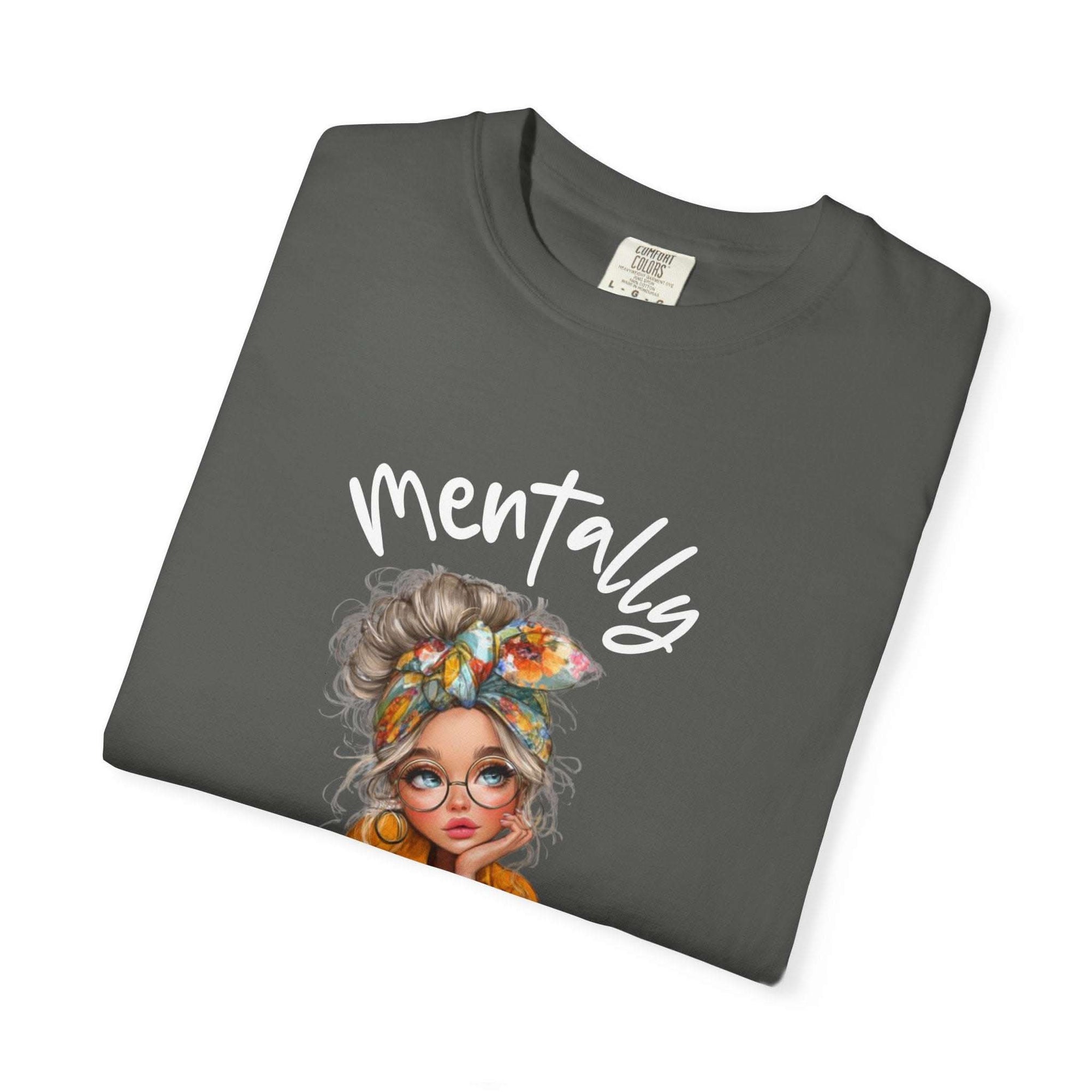 Folded dark gray t-shirt with a graphic of a woman's face and the word 'Mentally' on a white background