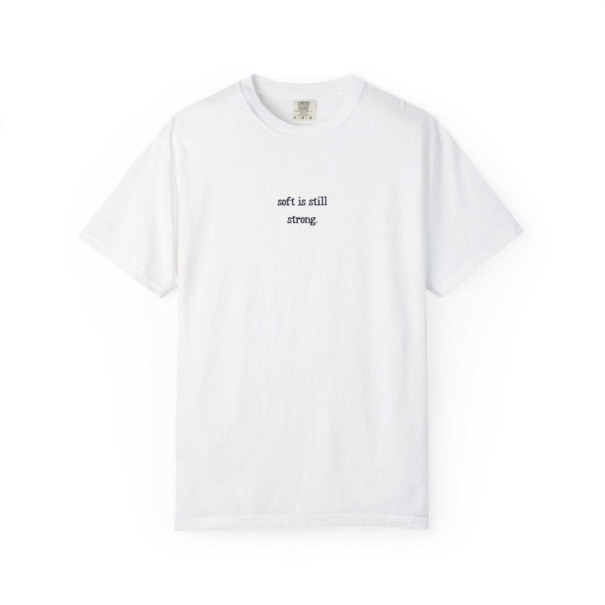 White t-shirt with text 'soft is still strong' on a white background
