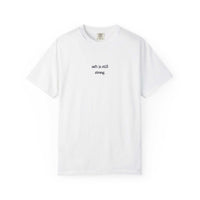 White t-shirt with text 'soft is still strong' on a white background