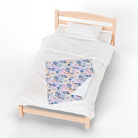 Coastal Cowgirl plush blanket with beach and horse design on bed