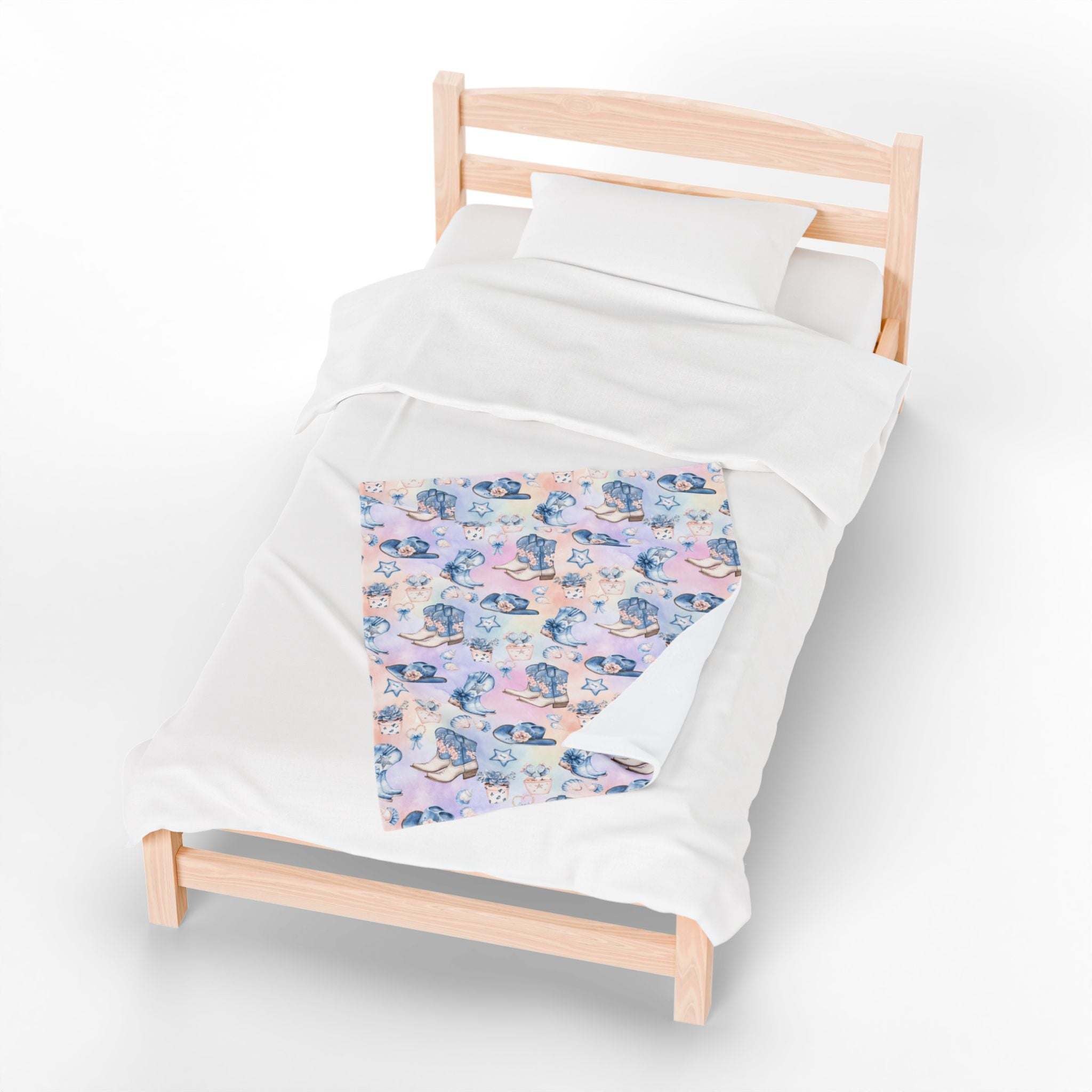 Coastal Cowgirl plush blanket with beach and horse design on bed