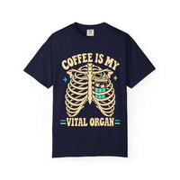 A navy blue short-sleeve t-shirt with a graphic print of a rib cage and a coffee cup, accompanied by the text 'COFFEE IS MY VITAL ORGAN' in beige and teal.