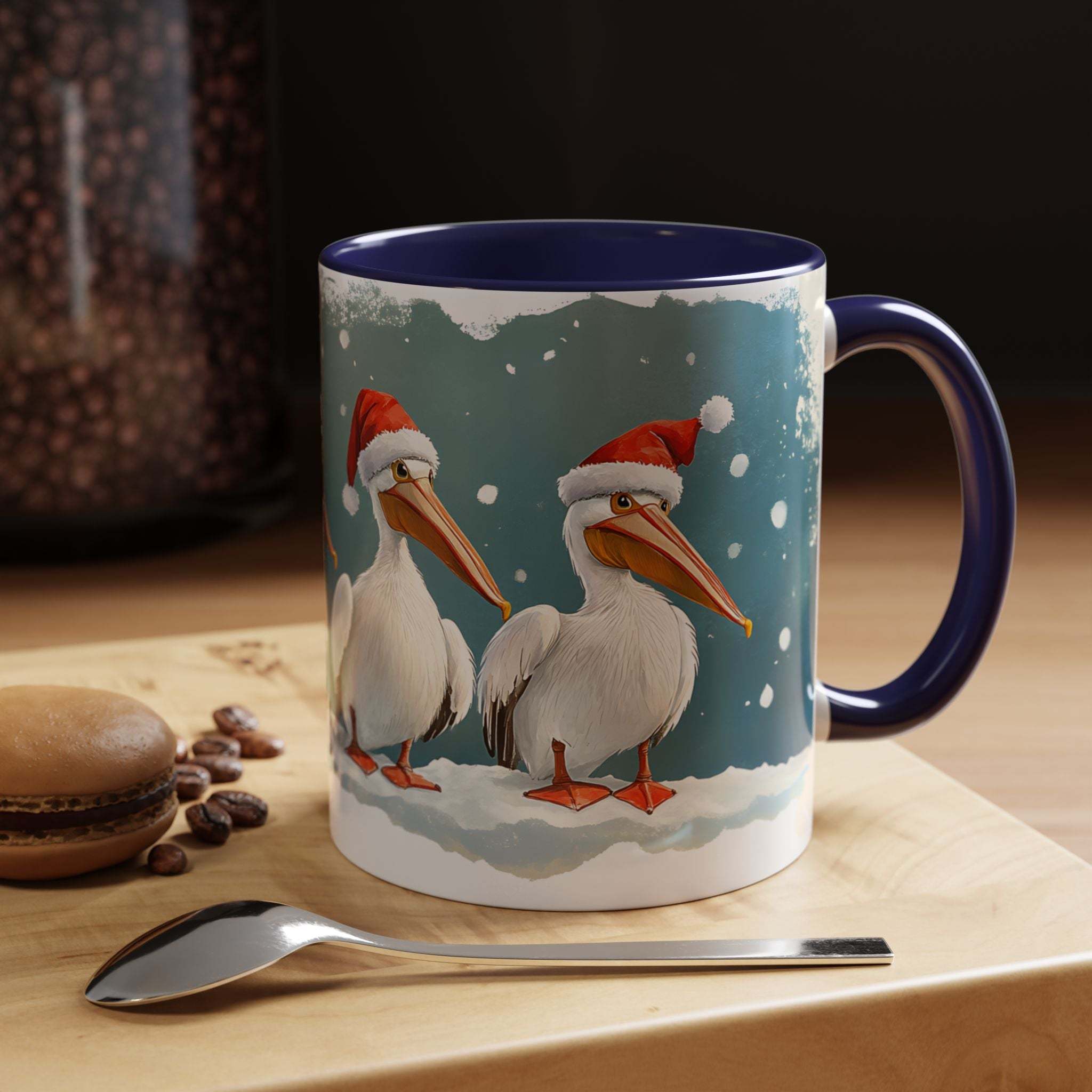 Mug with Christmas-themed design of pelicans wearing Santa hats on a table with coffee beans and a spoon.