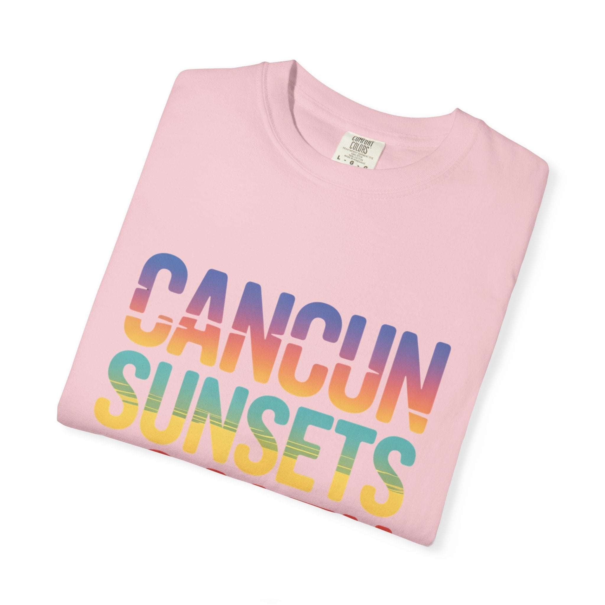 Pink t-shirt with 'Cancun Sunsets' text in rainbow colors on a white background