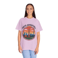Woman wearing purple garment-dyed T-shirt with Tokyo Adventures graphic and skyline design