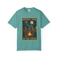 National Park After Dark t-shirt with campfire, Sasquatch, Mothman, and nocturnal creatures design on vintage-style garment-dyed fabric
