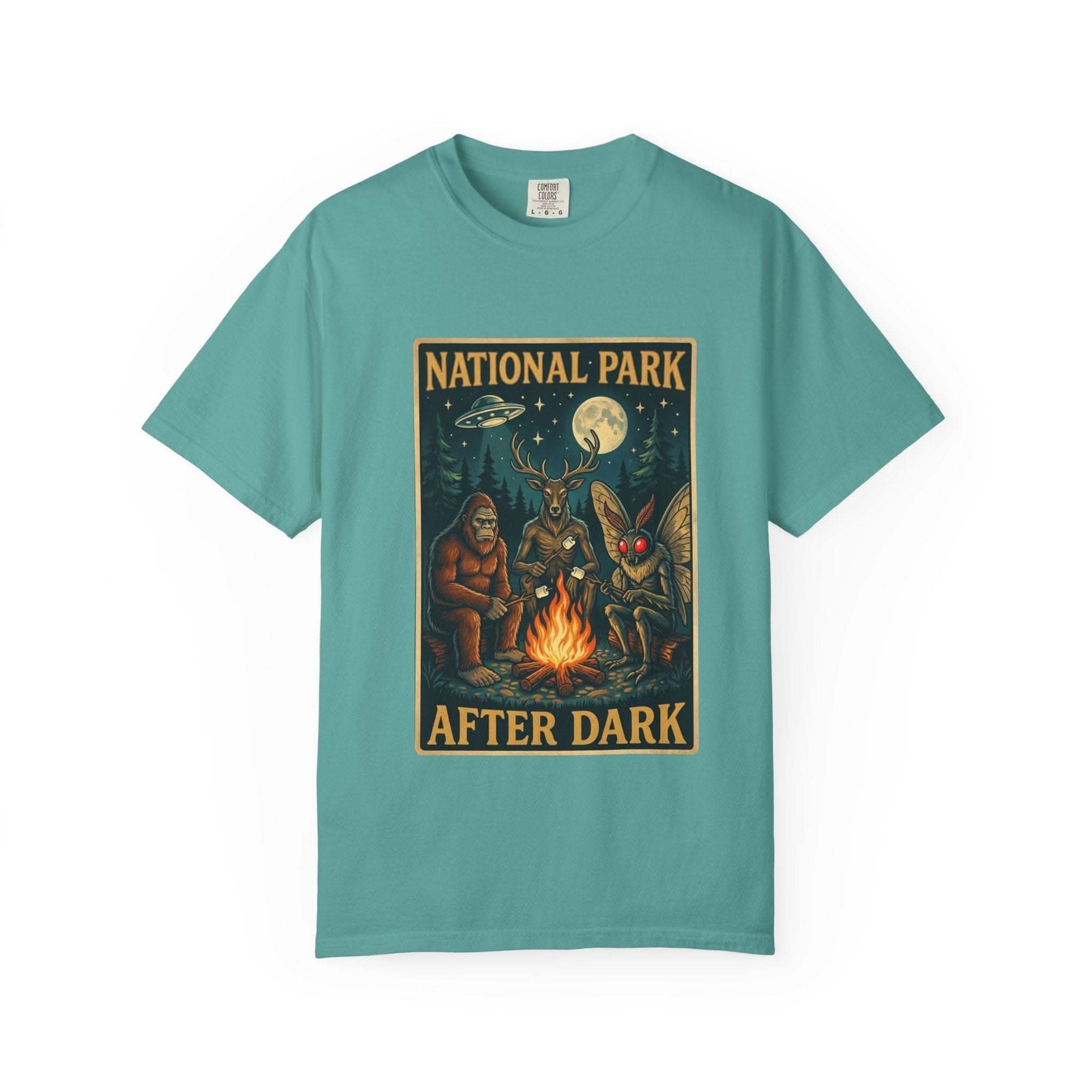 National Park After Dark t-shirt with campfire, Sasquatch, Mothman, and nocturnal creatures design on vintage-style garment-dyed fabric