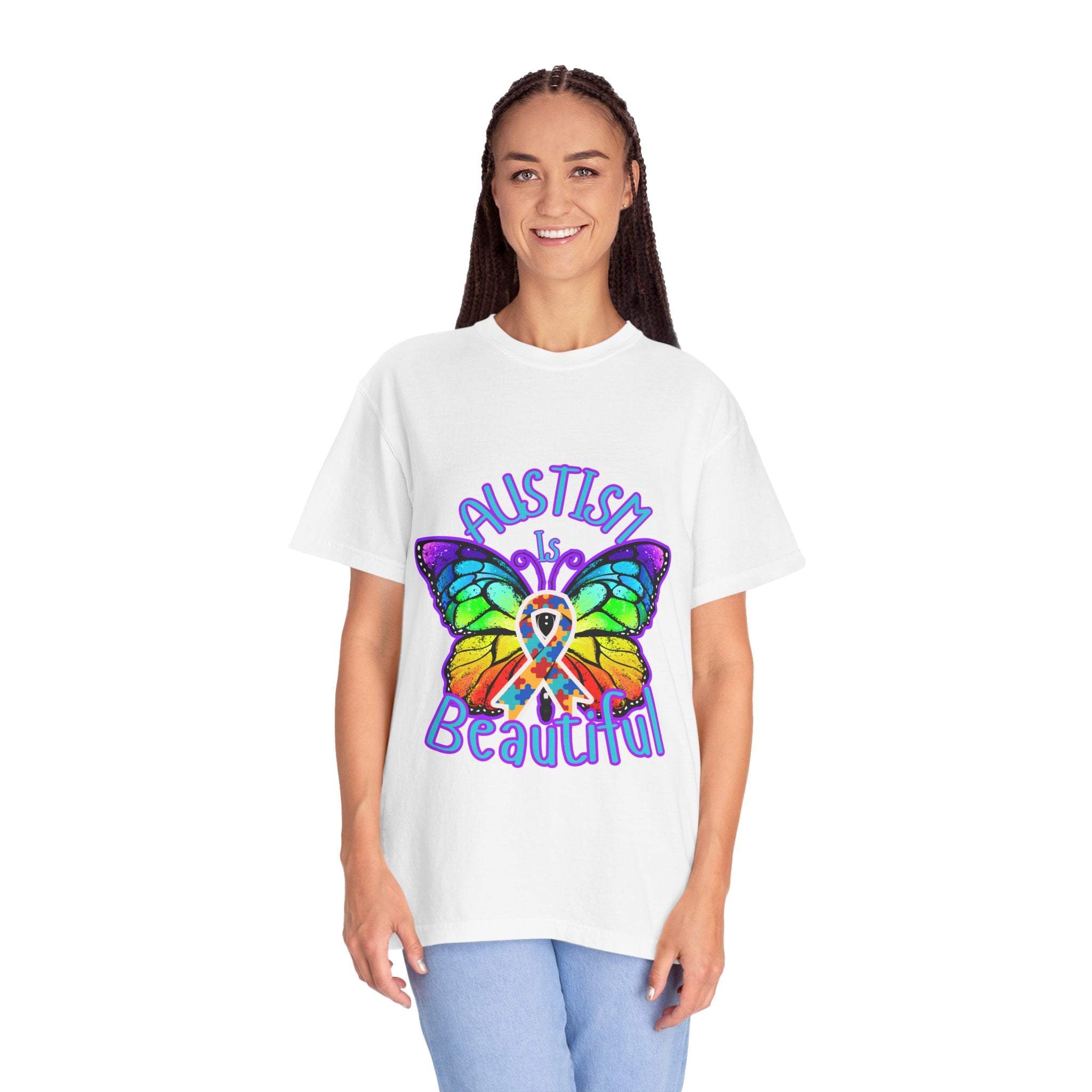 Woman wearing white Autism is Beautiful T-shirt with colorful butterfly design and autism awareness ribbon, unisex style, promoting autism acceptance and support