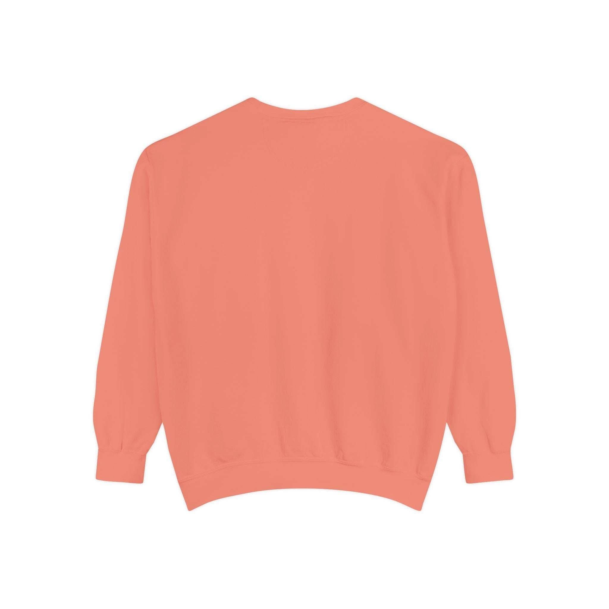 Back view of coral-colored unisex sweatshirt with ribbed collar, cuffs, and hem, part of the Iridescent Merry Christmas holiday collection