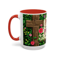 Mug with floral design and wooden cross on a white background