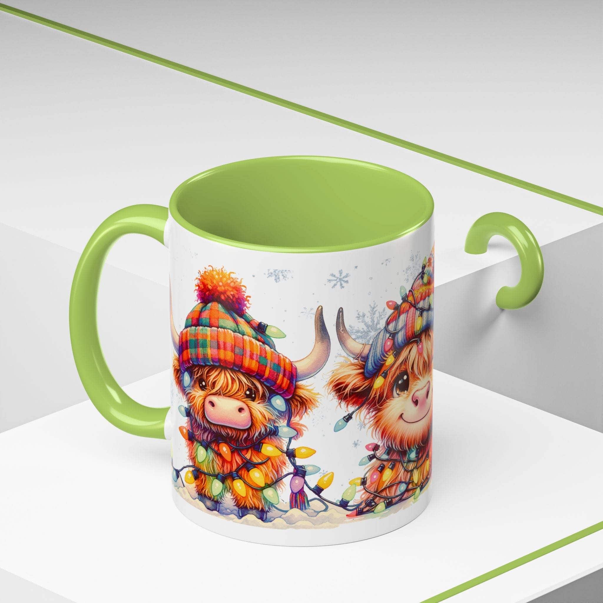 Mug with cartoon Highland cow design and green interior on a white background