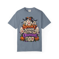 Flat lay of a blue jean Halloween mahjong T-shirt with ghosts, pumpkins, mahjong tiles and “Spooky Season, Same Tile Obsession” lettering.