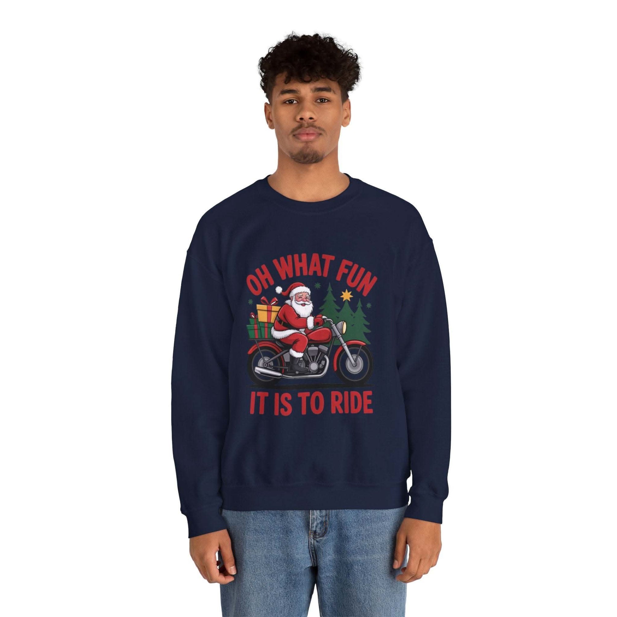 Man wearing navy Motorcycle Santa Sweatshirt with Santa on motorcycle and holiday gifts design in festive setting
