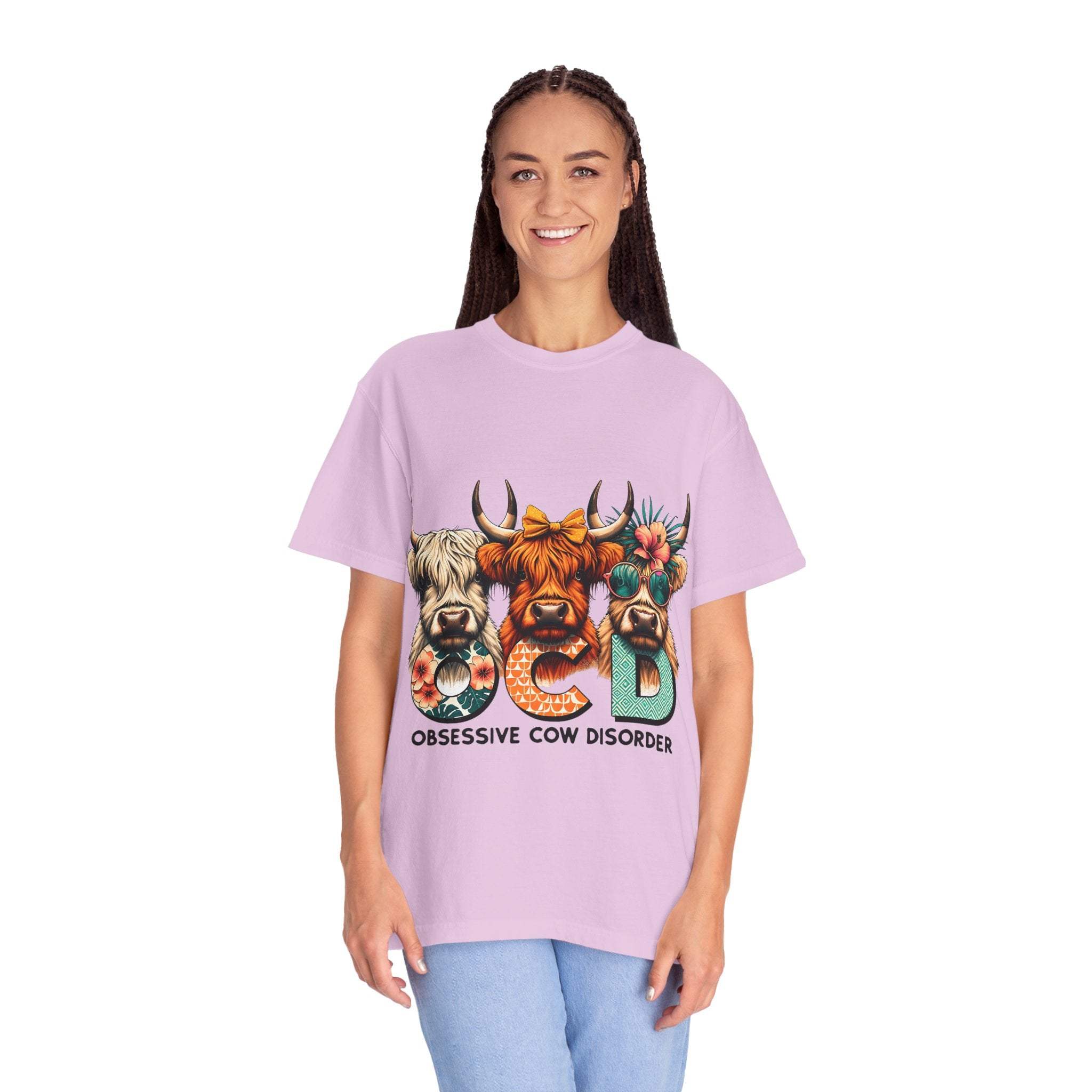 Woman wearing funny OCD Obsessive Cow Disorder T-shirt with colorful cow design on lavender garment-dyed fabric