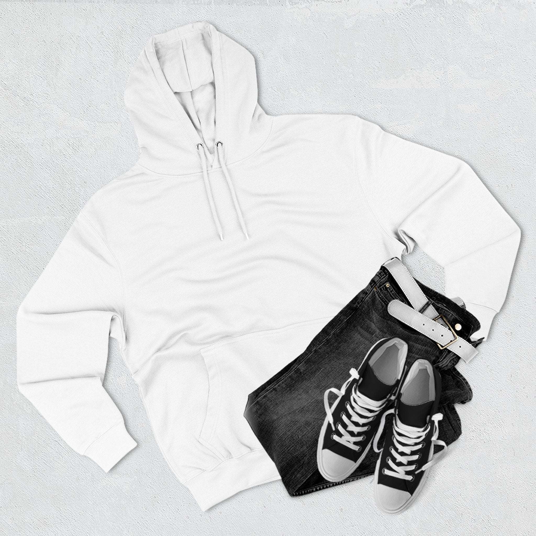 White fleece hoodie with hood and kangaroo pocket, paired with black jeans and black sneakers