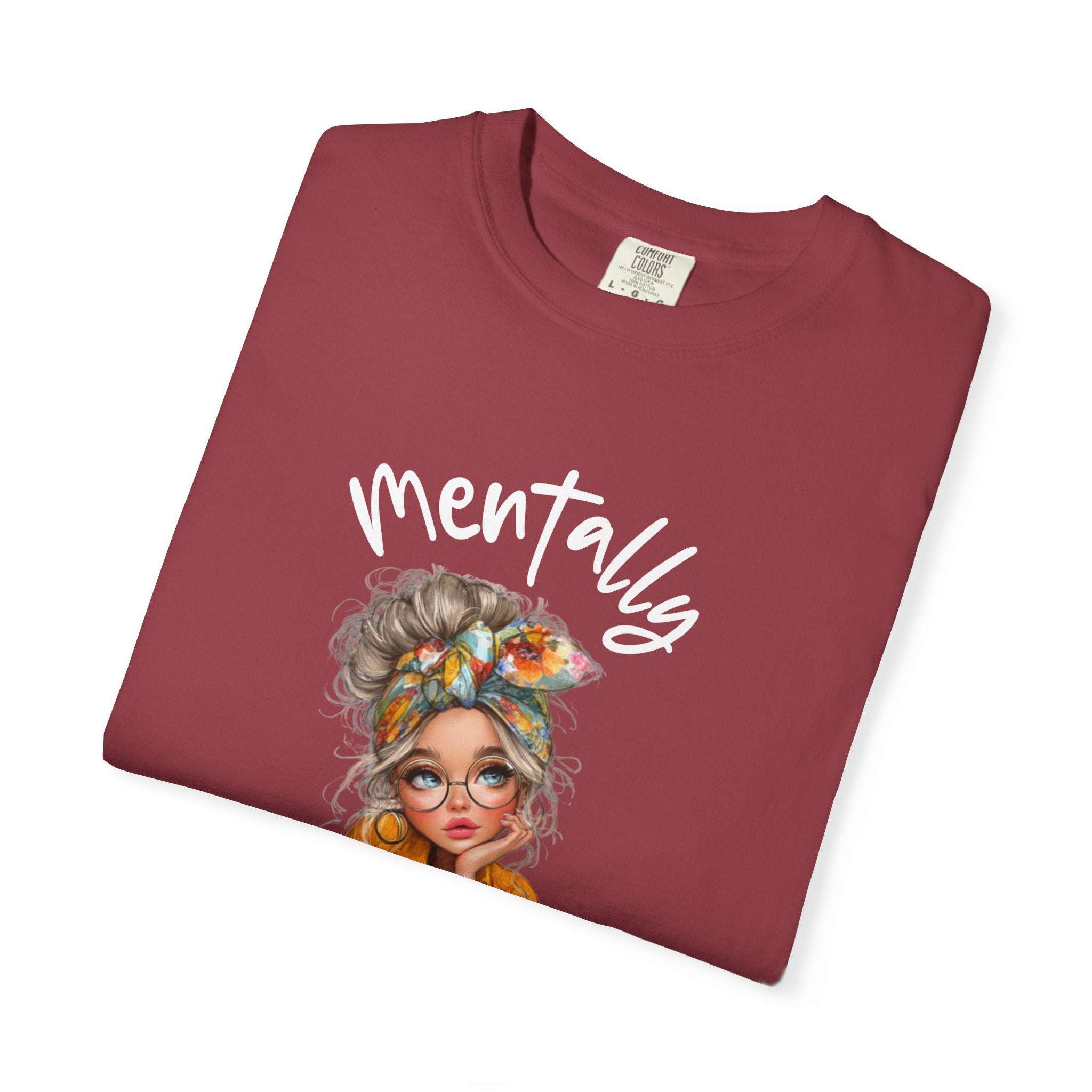 Maroon t-shirt with a graphic of a woman's face and the word 'Mentally' on a white background