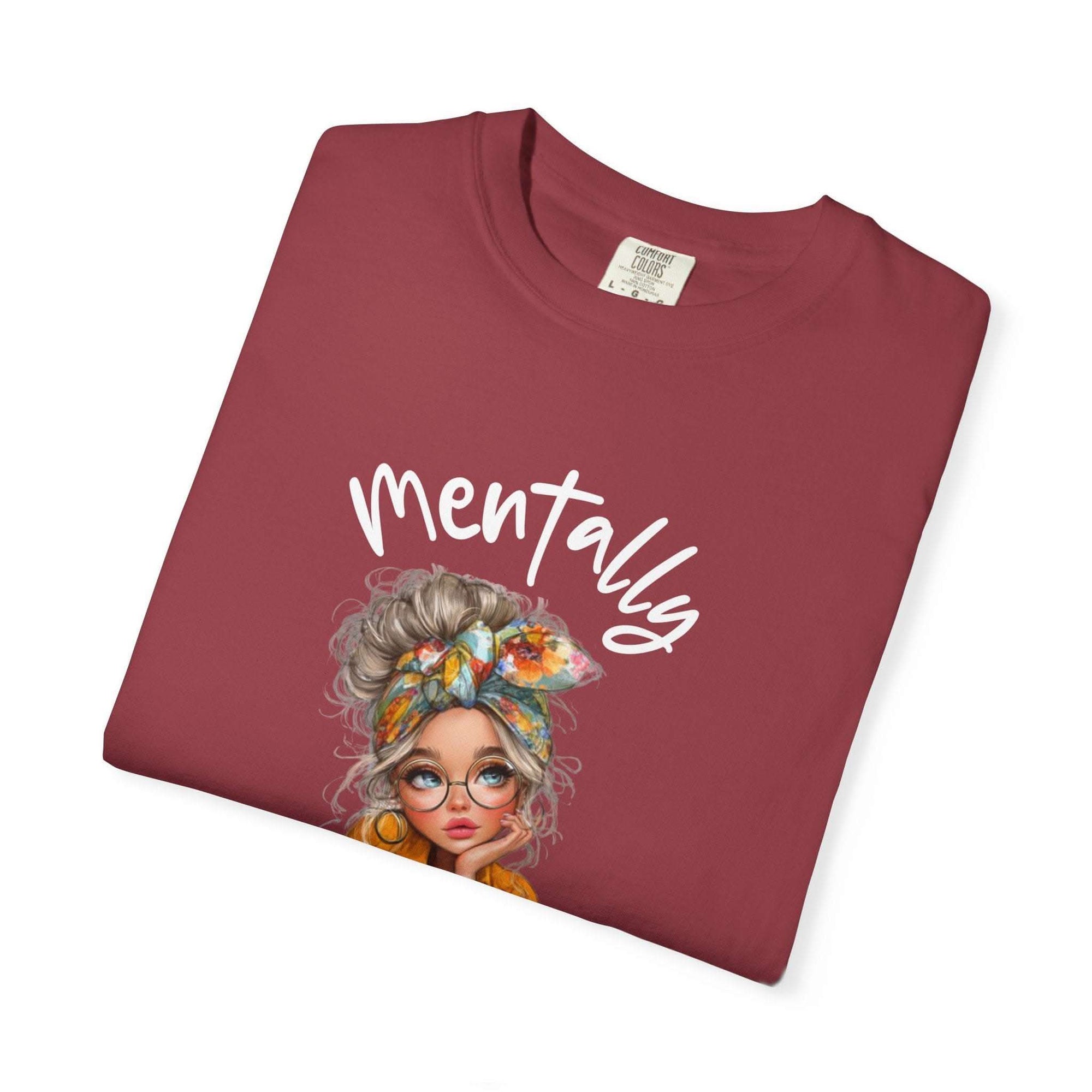 Maroon t-shirt with a graphic of a woman's face and the word 'Mentally' on a white background
