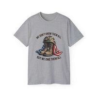 Unisex gray Veteran T-shirt with military boots, helmet, and American flag design and "We Don’t Know Them All But We Owe Them All" text