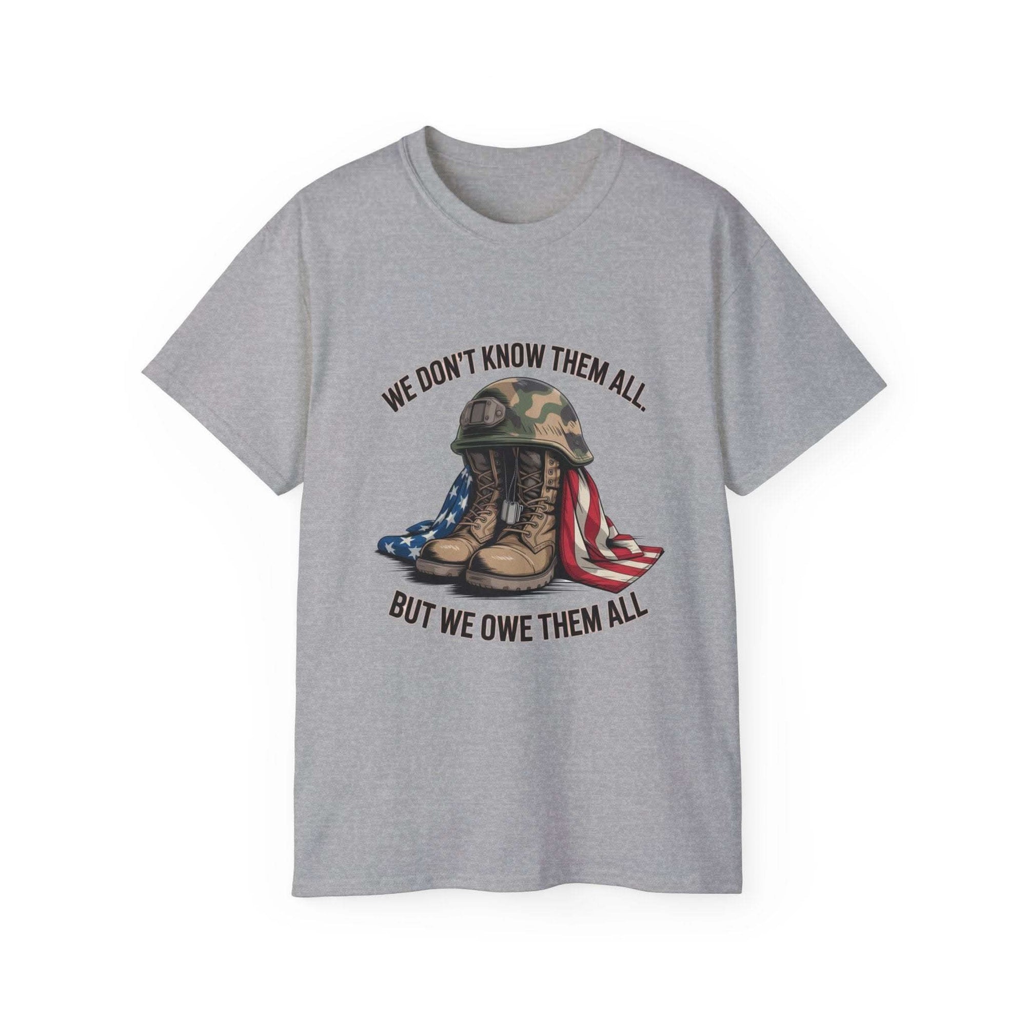 Unisex gray Veteran T-shirt with military boots, helmet, and American flag design and "We Don’t Know Them All But We Owe Them All" text