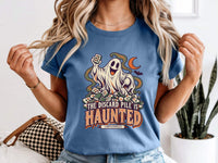 Model wearing blue jean Comfort Colors 1717 Halloween mahjong T-shirt with a ghost holding a tile and “The Discard Pile Is Haunted (Obviously)” lettering.