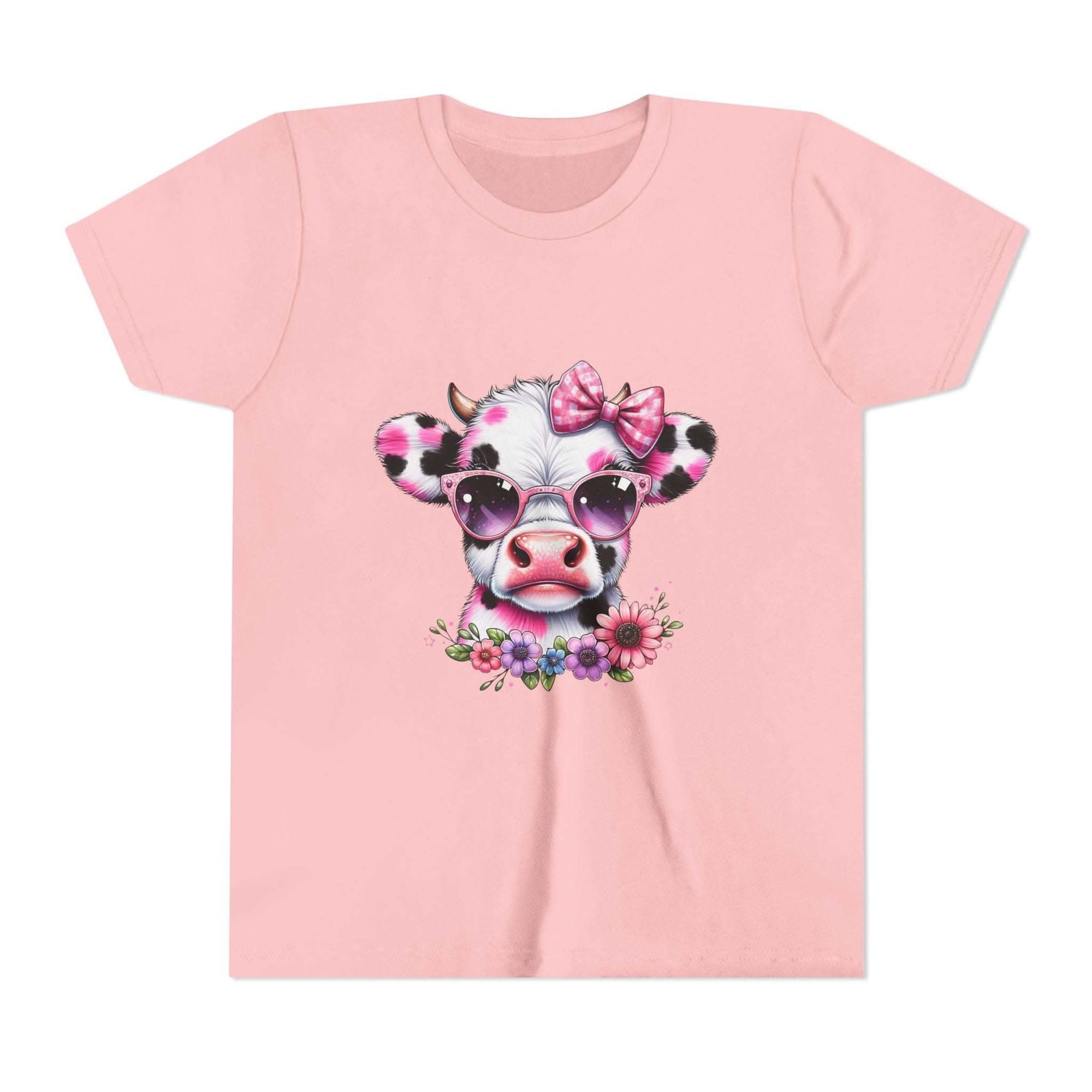 Pink t-shirt with a cow design wearing sunglasses and a bow, on a white background