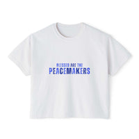 Women's white boxy tee with "Blessed be the Peacemakers" text in blue, casual and vintage style