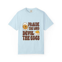 White cotton t-shirt featuring 'Praise the Lord, Devil the Eggs' design, perfect for Easter and Christian apparel.